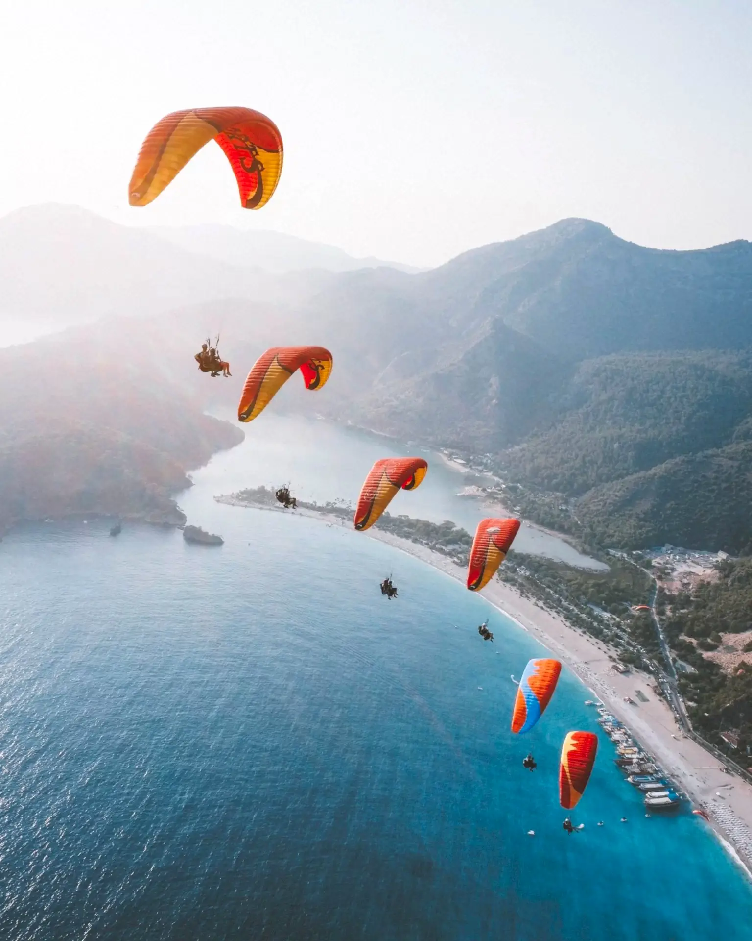 SAMSUNG CAMERA PICTURES Six paragliders flying in perfect formation, side by side, showcasing precision and teamwork in the skies